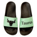 Black slides with mint green straps featuring Taurus logo